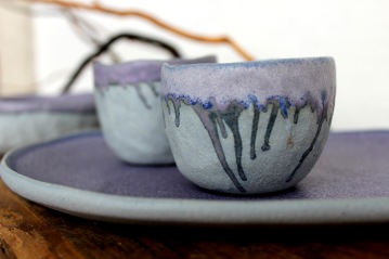 Smalvivid violet pinchpots on a plate